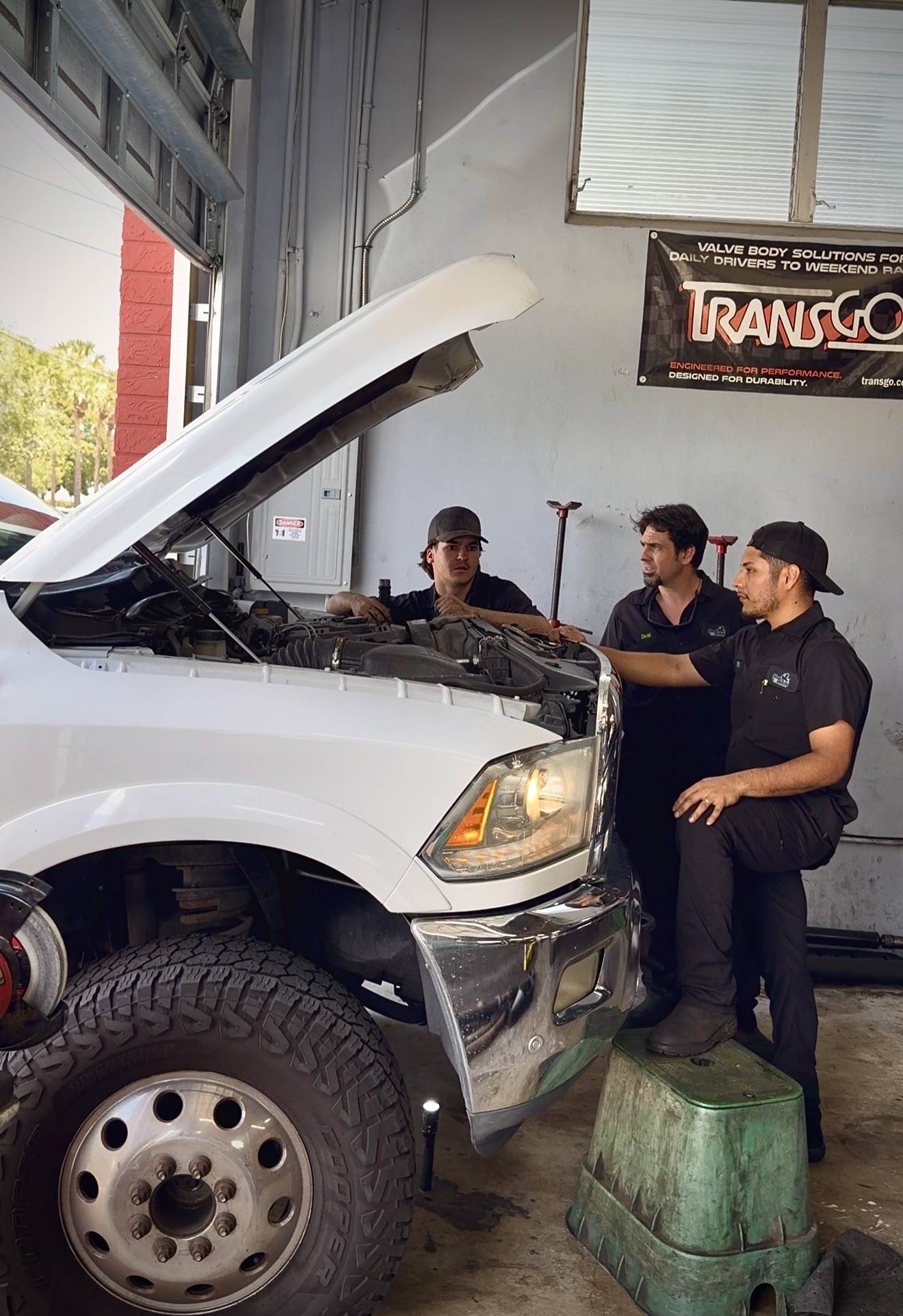 Jax Media Co team working on a diesel truck in the shop
